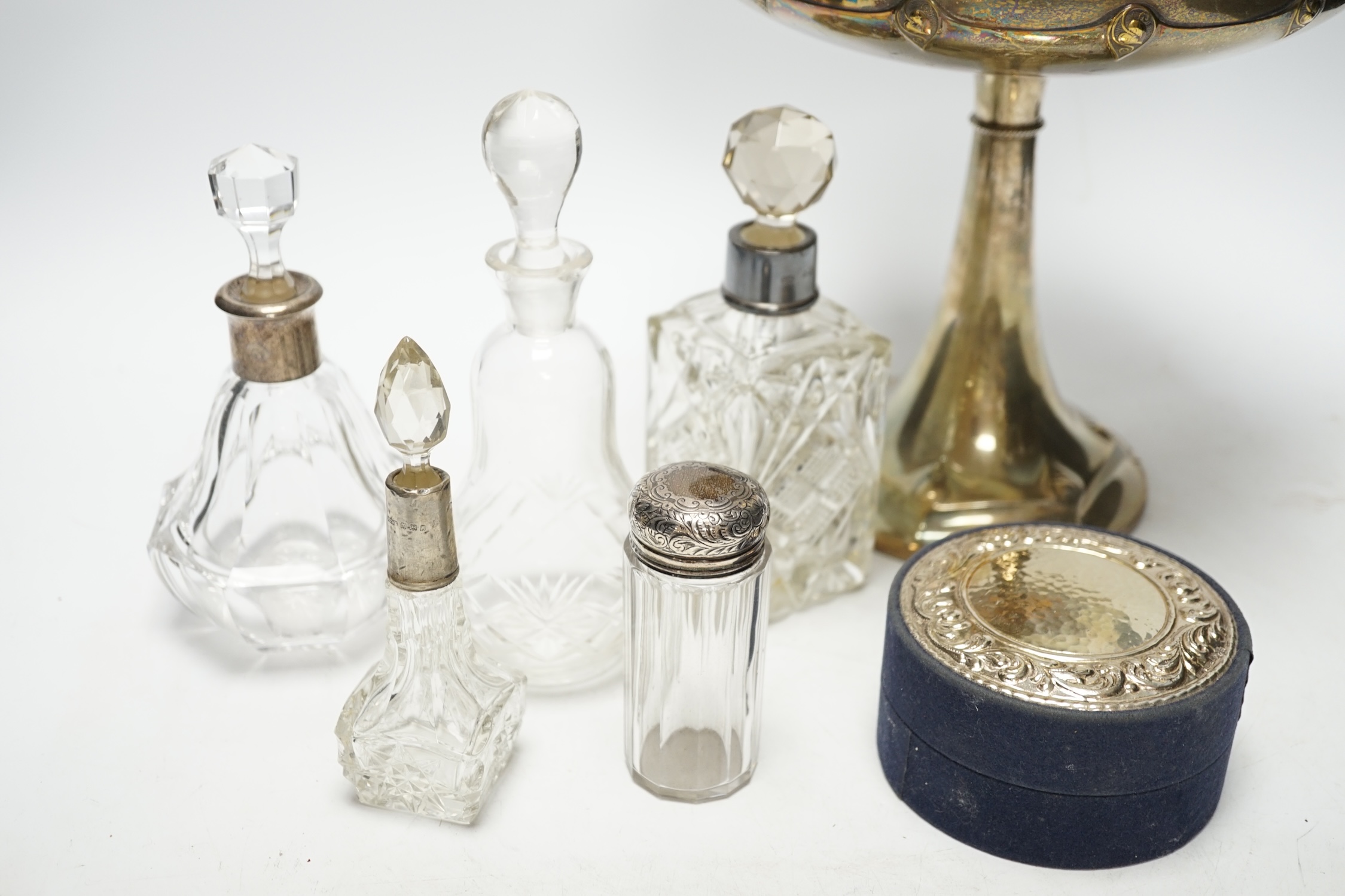 A WMF tazza, 21cm high, and five bottles, two with silver collars, and a cylindrical box